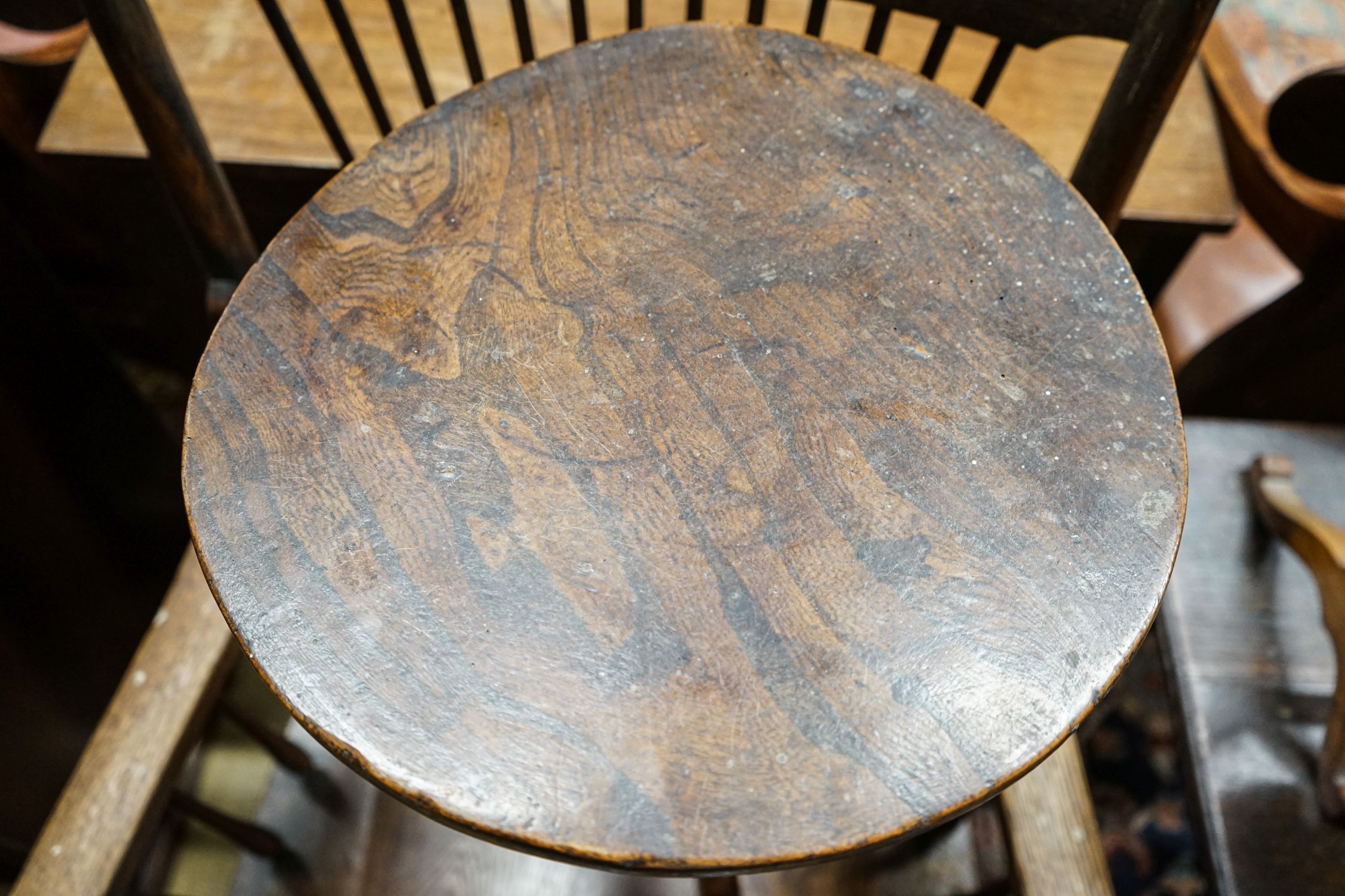 A mid 18th century elm tripod table, diameter 35cm (a.f.), height 57cm, a late Victorian oak stick back chair and two toilet mirrors